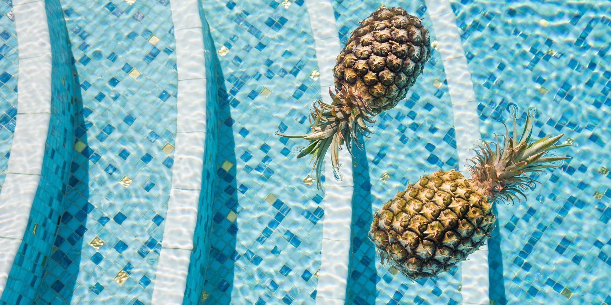 Two pineapples floating on a pool at Crown hotels Perth