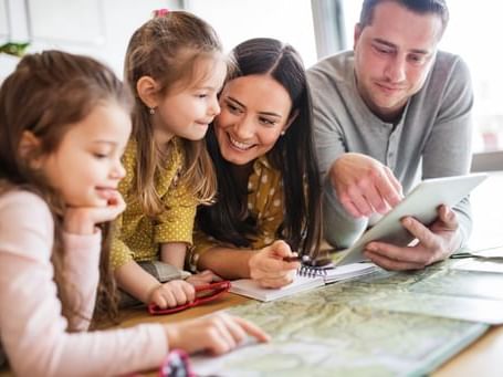 family looking at map on table