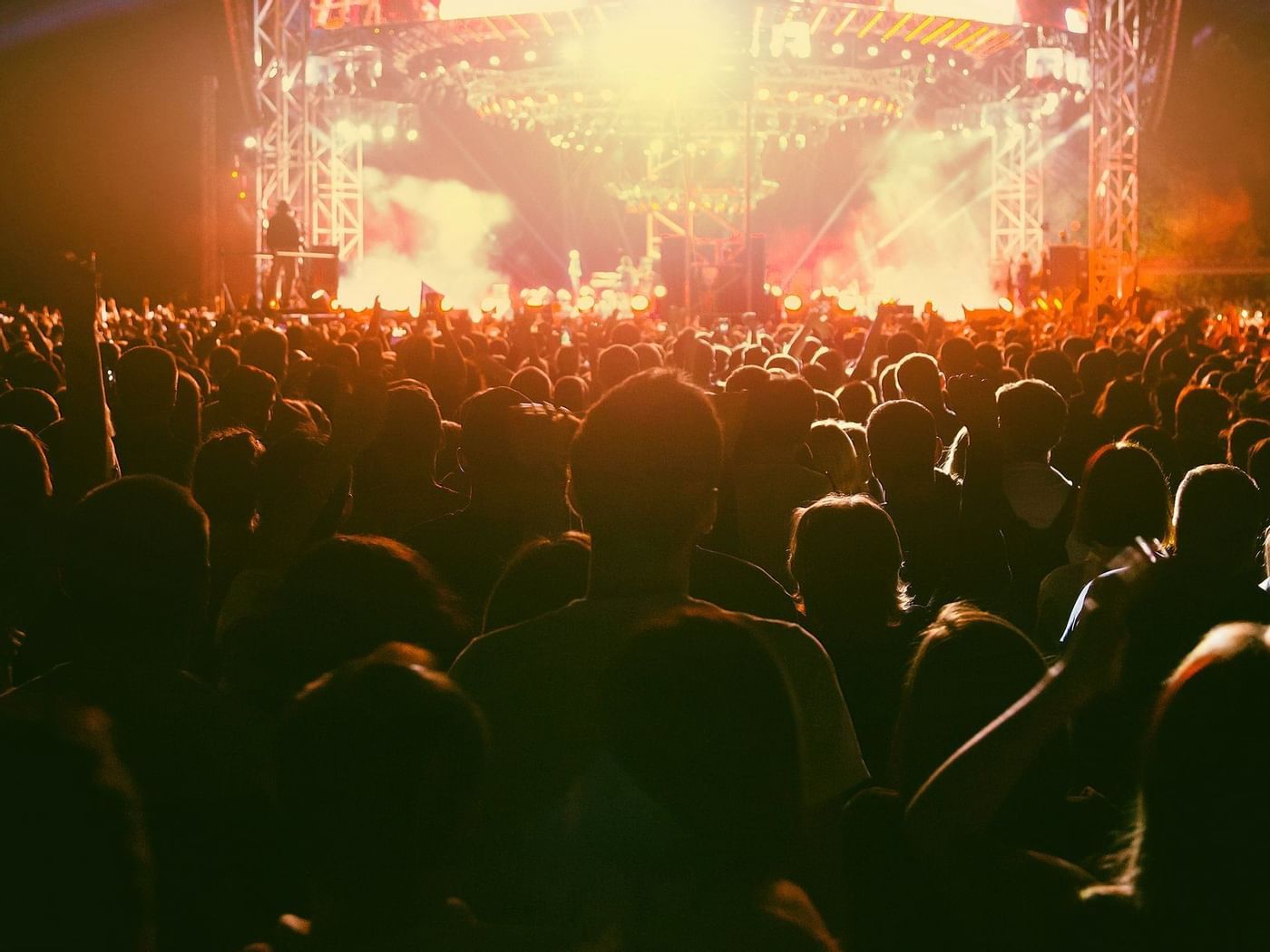 Crowd enjoying in a concert at night near One Hotels