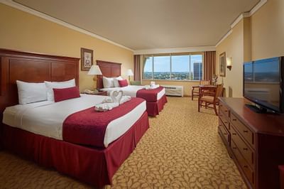 room with two beds, small table for two and