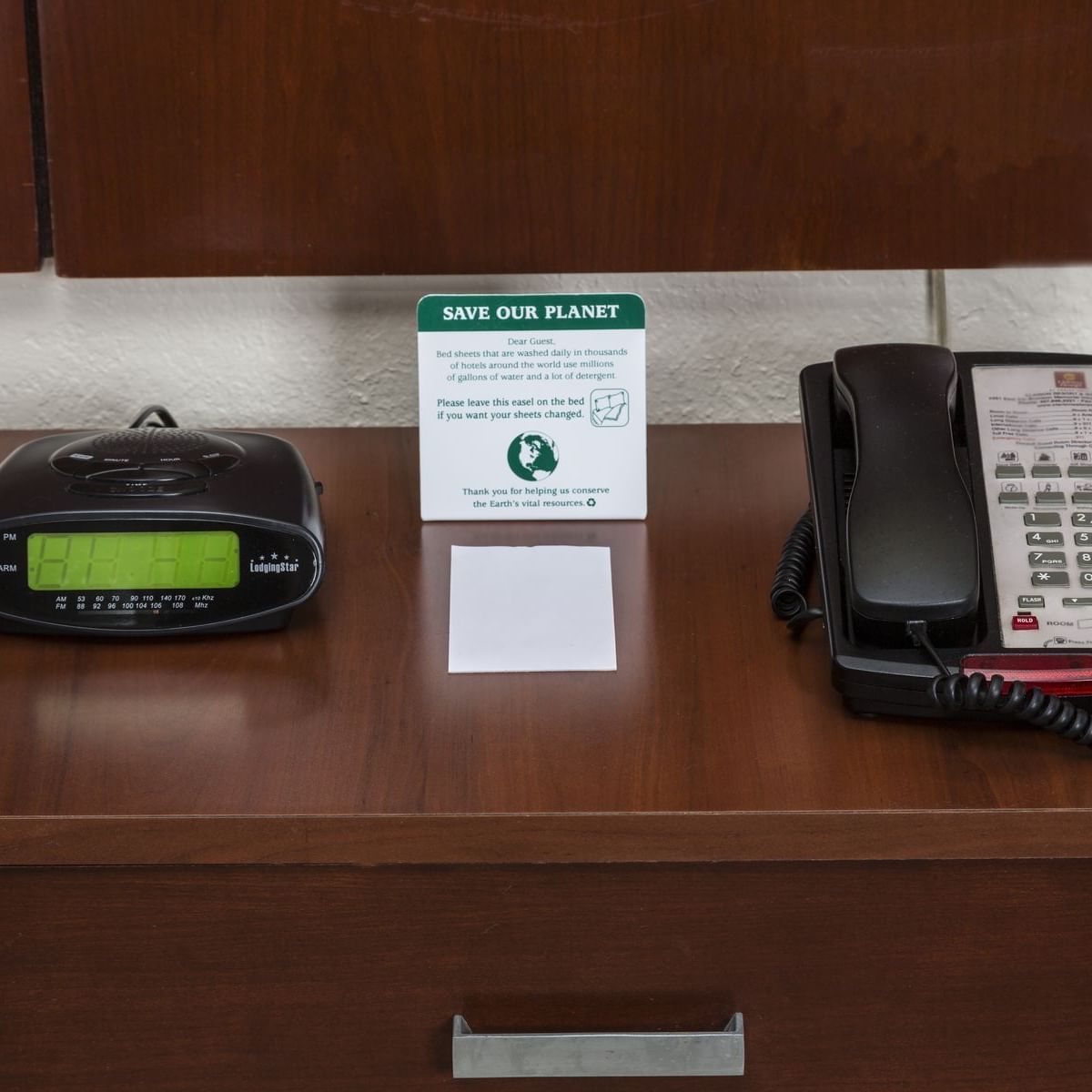 Telephone desk & alarm in a suite at Flamingo Express Hotel