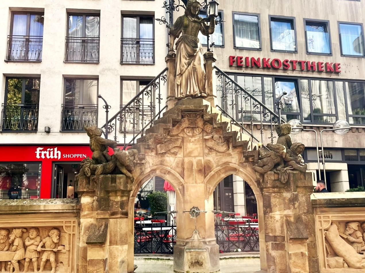 Fountain with elves and tailor’s wife carved at Wallraf-Richartz-Museum near Classic Hotel Harmonie