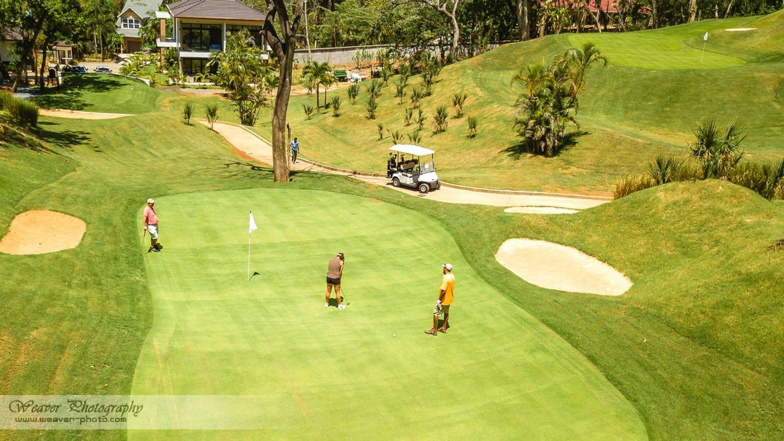 three men playing golf