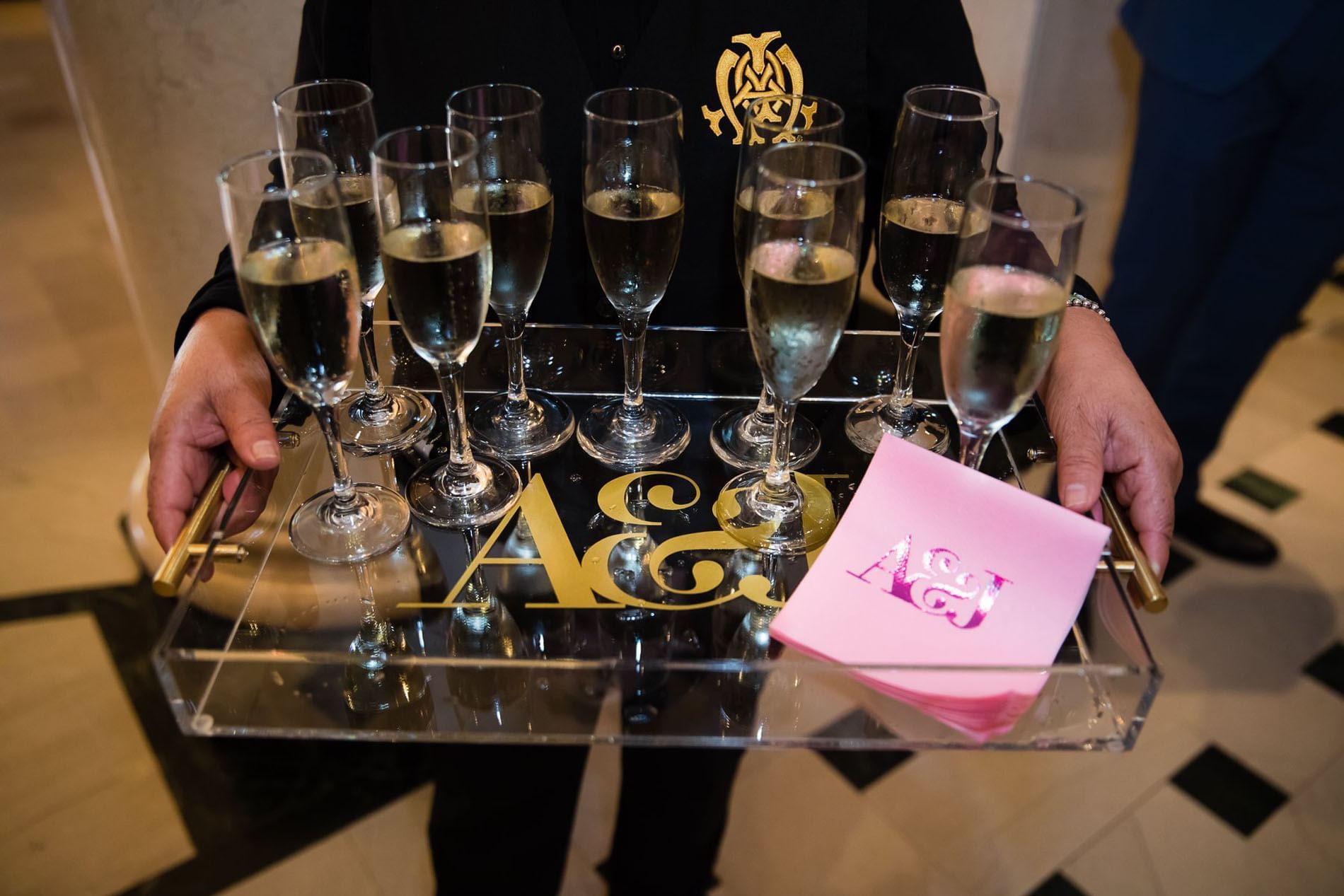 Waiter holding drinks in Mark Coffee Shop at The Mayo Hotel