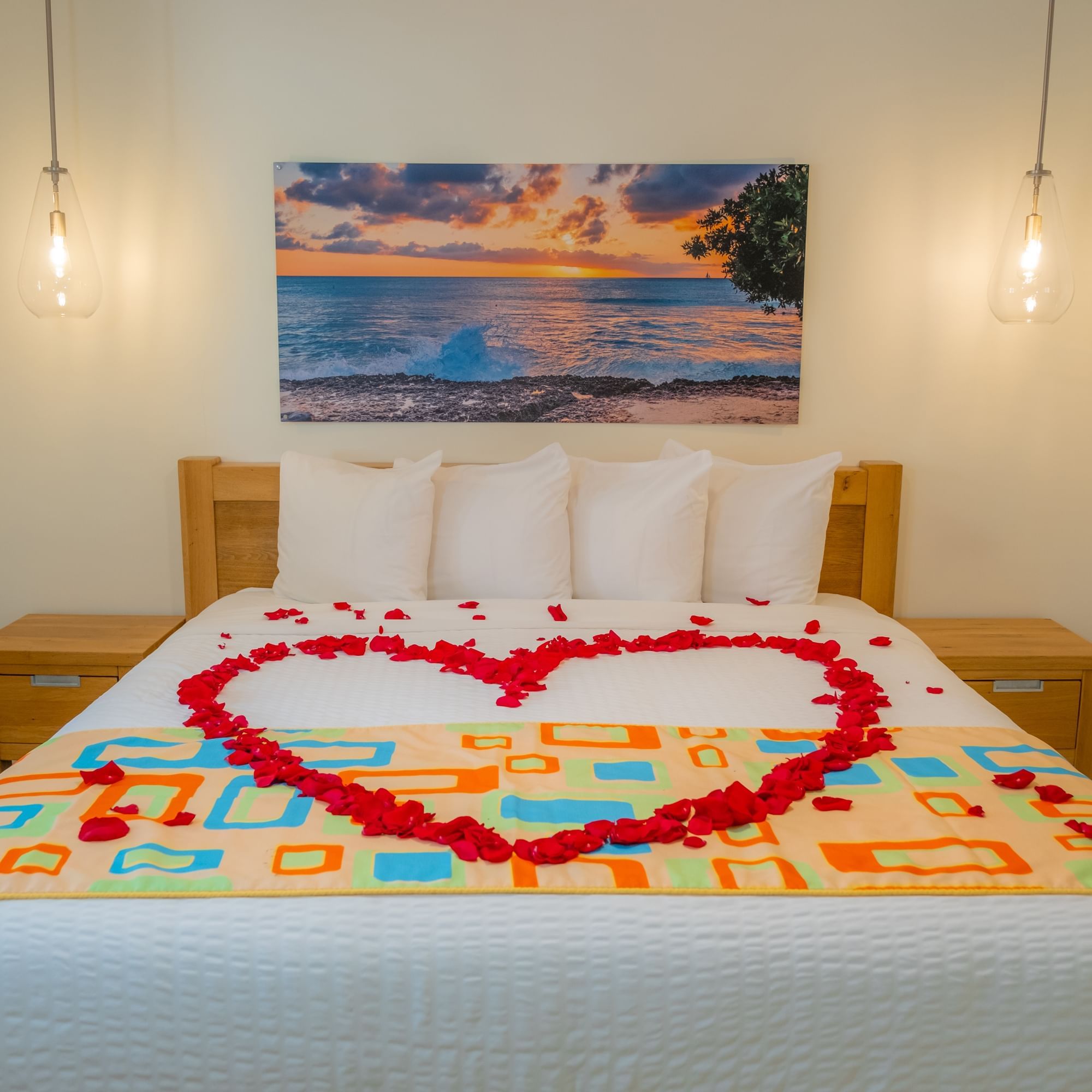 bed with rose petals in a heart shape