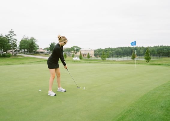 Lady playing on a golf course in Maine Golf Resort at Sebasco Harbor Resort