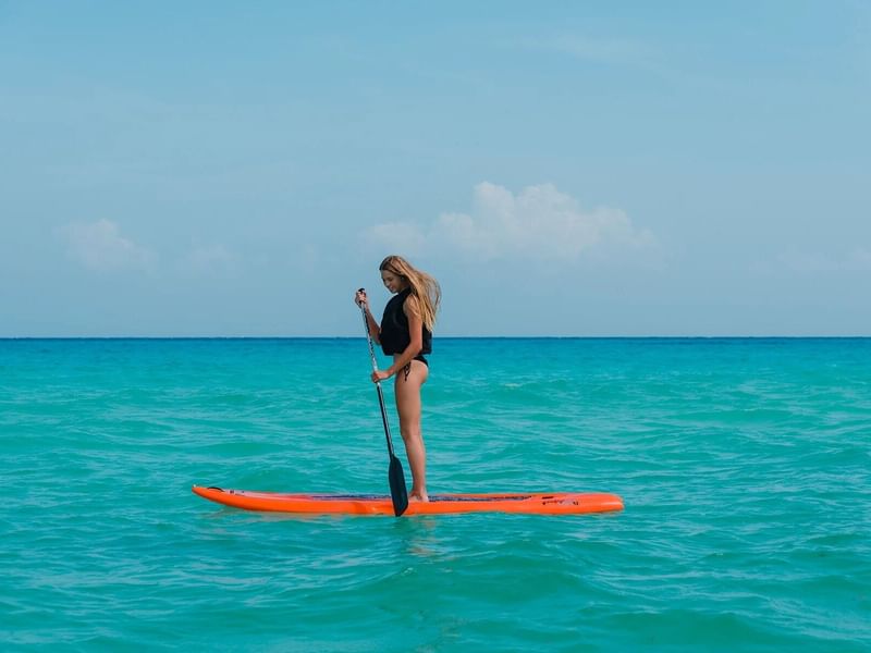 Woman doing Paddle surfing in Playa del Carmen