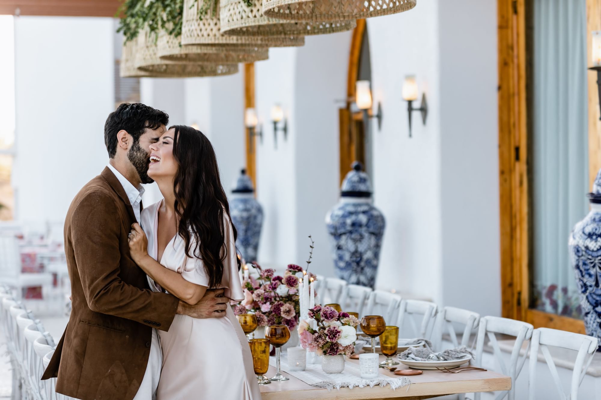 A man kisses his girlfriend at a wedding at Marquis Los Cabos