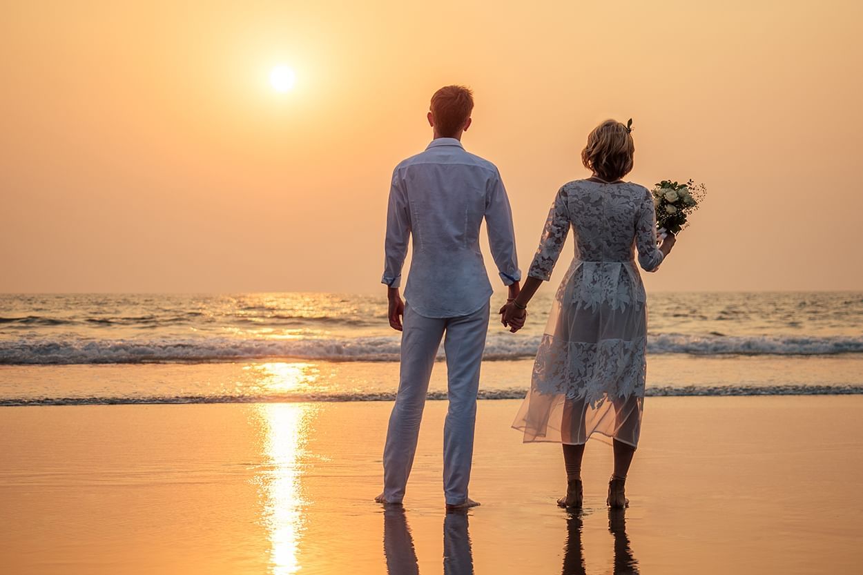 Bride & groom on beach at sunset near Holiday Inn Montego Bay