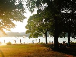 a group of people walking by a lake