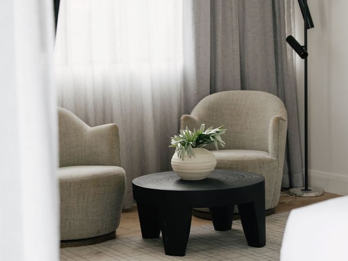 Sunset Junior Suite – Elysium Floor at Elysium Manly featuring two armchairs by a coffee table, best places to stay in Manly