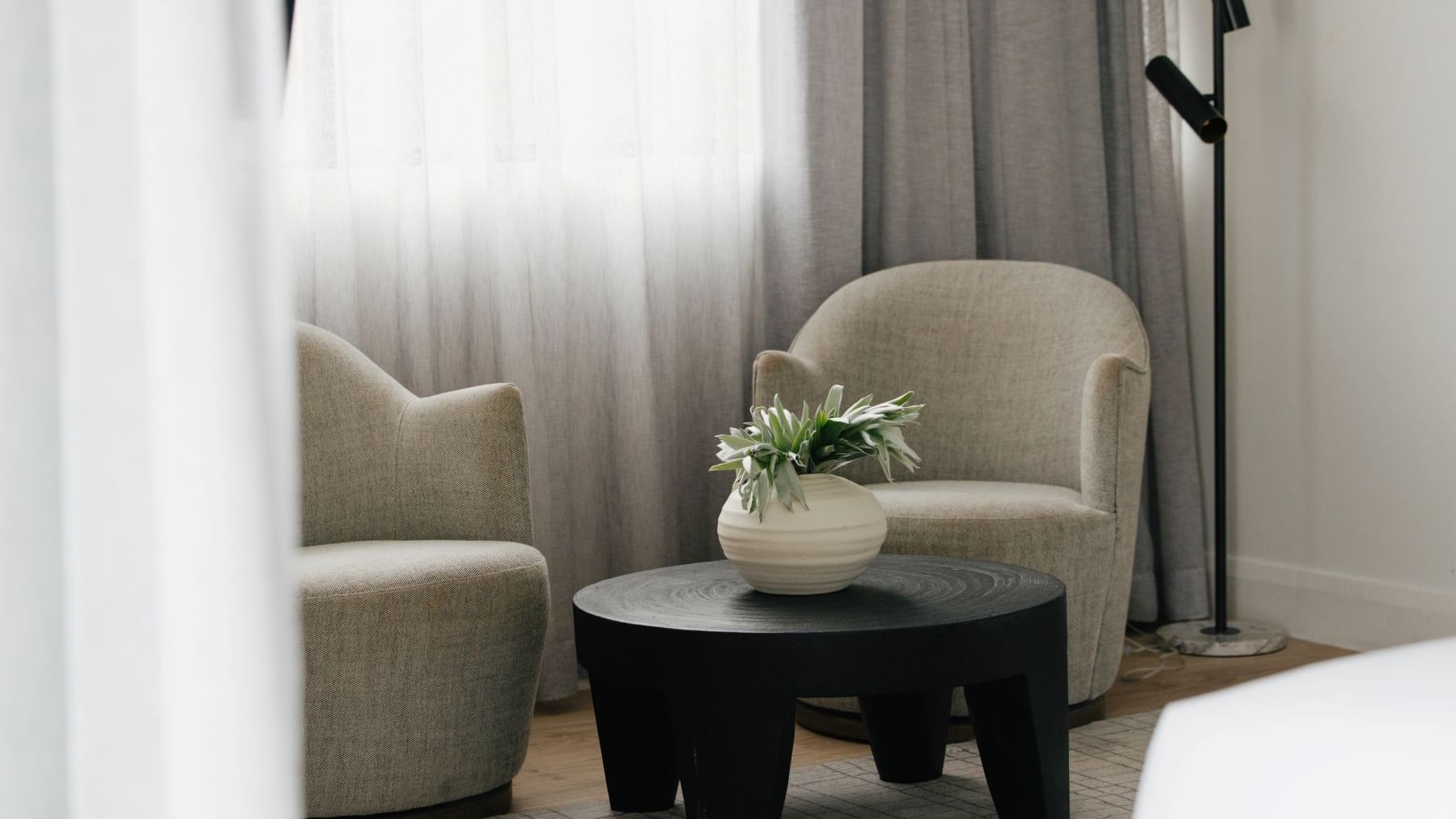 Sunset Junior Suite – Elysium Floor at Elysium Manly featuring two armchairs by a coffee table, best places to stay in Manly