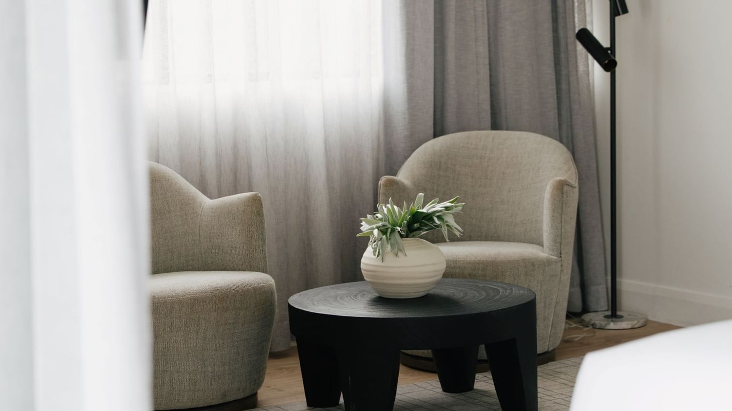 Sunset Junior Suite – Elysium Floor at Elysium Manly featuring two armchairs by a coffee table, best places to stay in Manly