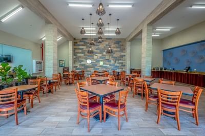 Hotel dining area with wooden table, chairs & decor at Irazu Hotel