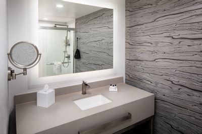 Marbel sink featuring vanity mirror in River View Two Room Suite with King Bed at River Street Inn