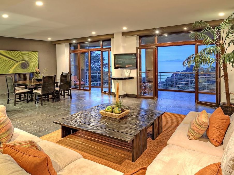 Living area with a TV and comfy sofa in Treetop Ocean View Suites at Los Altos Resort