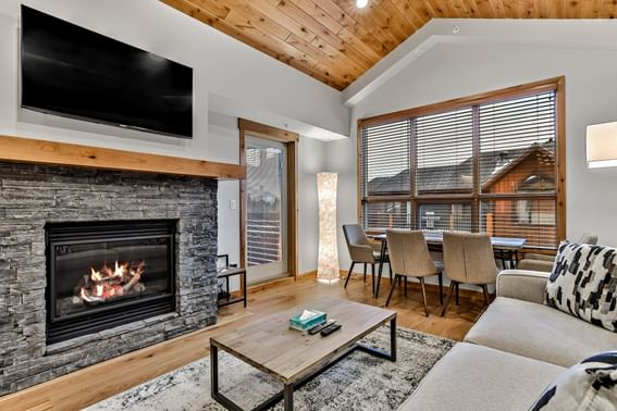 409 White Spruce Lodge One Bedroom Elevated Condo living room with fireplace, sofa and dining area at Spring Creek Vacations