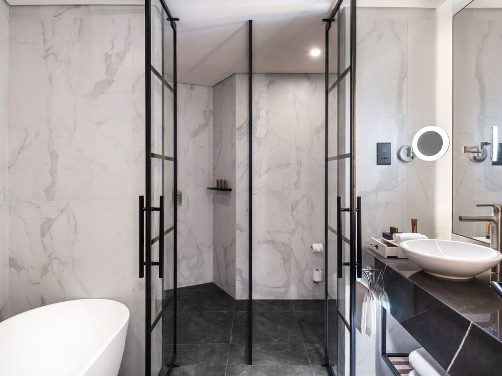 Bathroom vanity with a bathtub in Paramount Suite at Paramount Hotel Midtown