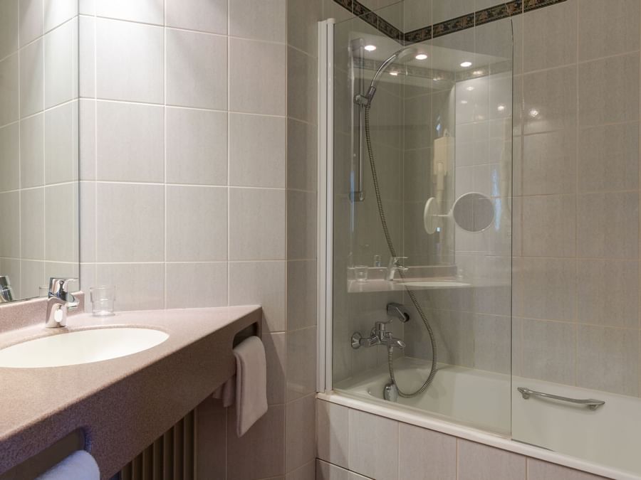 Bathroom shower & vanity in a room at Hotel Rey du Mont Sion