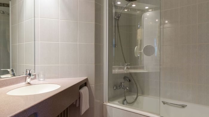 Bathroom shower & vanity in a room at Hotel Rey du Mont Sion