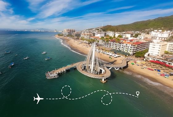 An aerial view of the famous circular ocean pier and sandy beach resort of Playa Los Arcos Beach Resort & Spa during daytime