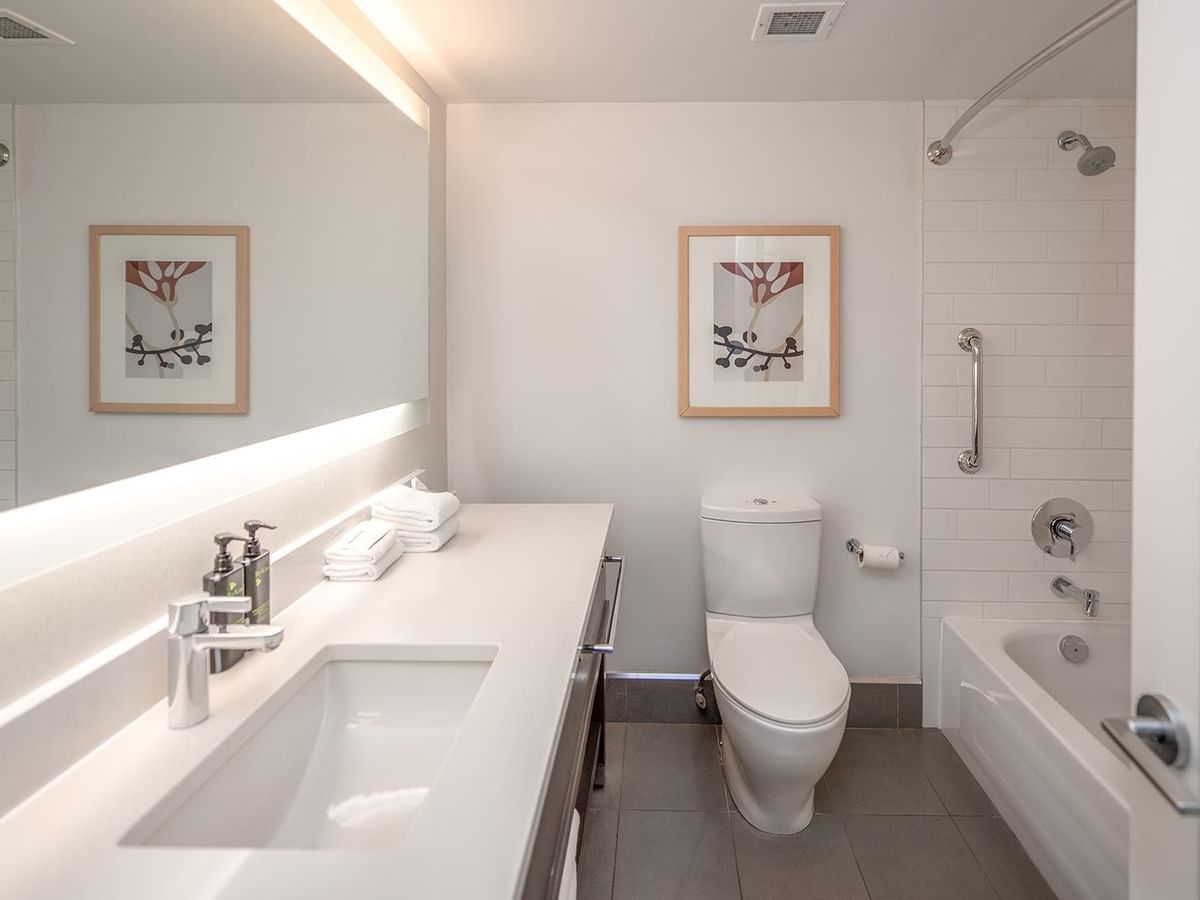 Modern bathroom with tub and toilet in Coast Two Queens room at Coast Bastion Hotel in Nanaimo.