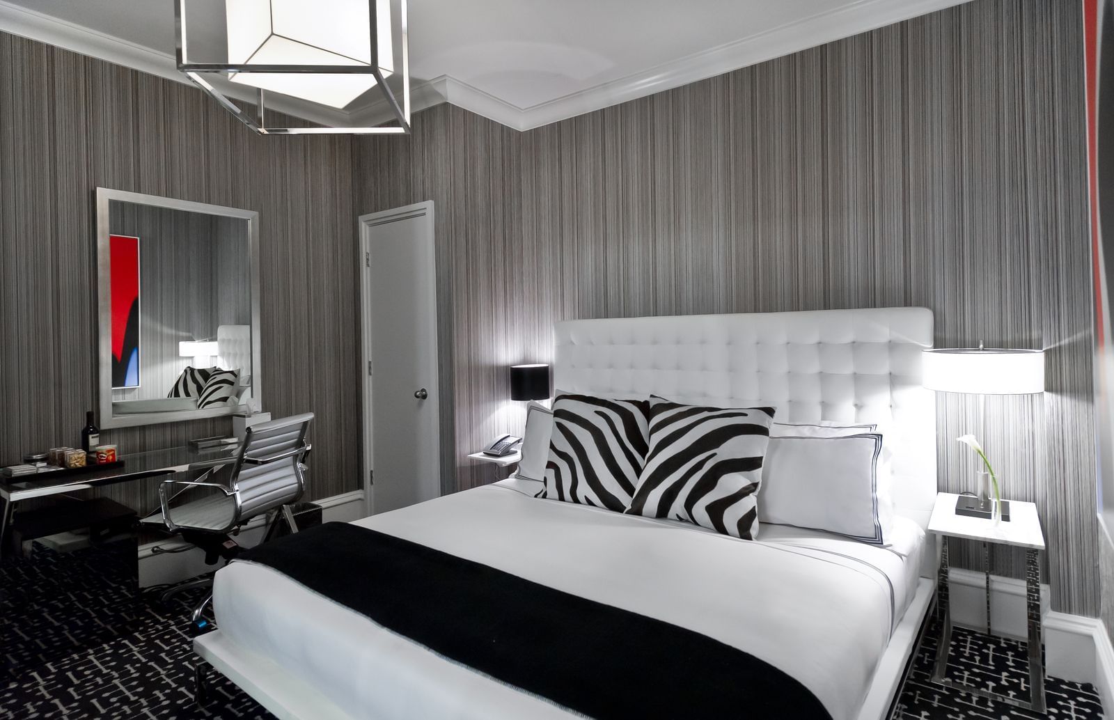 bed in a hotel room with zebra pillows