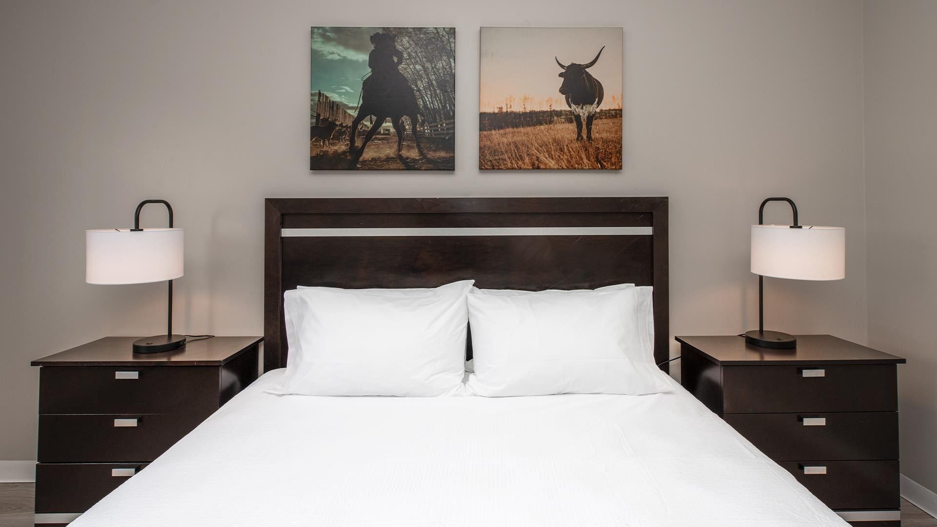 White bed with brown headboard and nightstands at Coast Innisfail Hotel