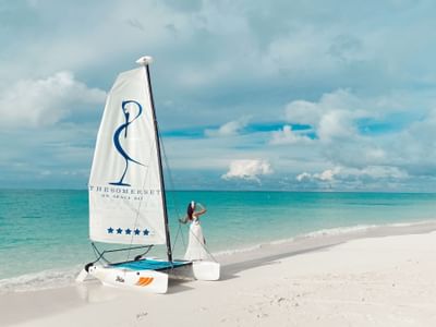 Lady standing at the Somerset On Grace Bay boat at the beach