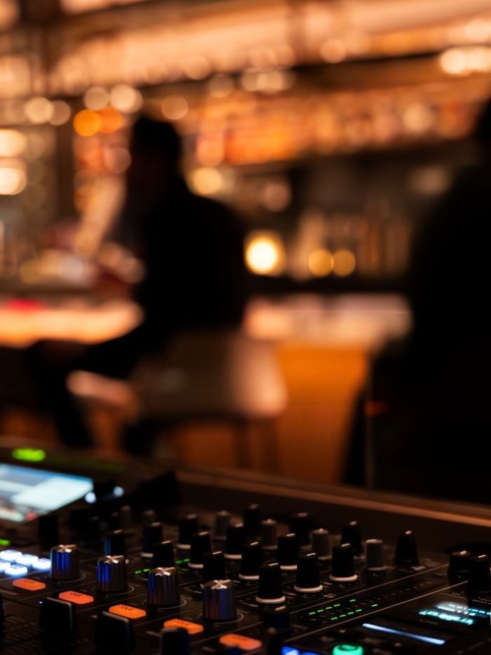 DJ equipment with people in The May Fair Bar