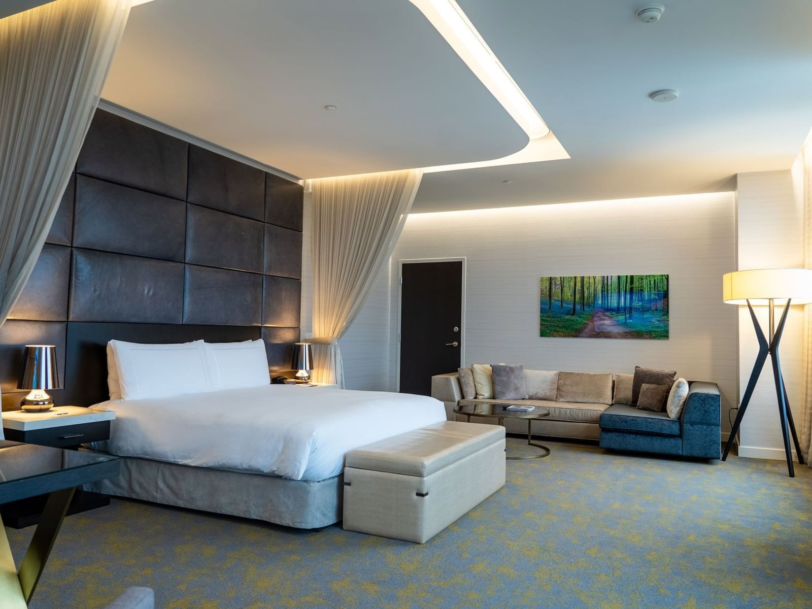 Bed and Seating area with elegant furniture in Royal King at Hotel X Toronto