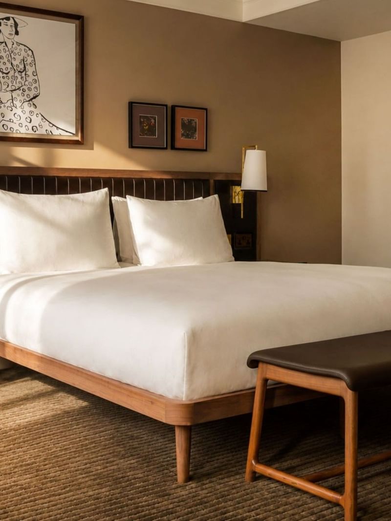 Collection Superior room with white bedding, wooden furniture, wall sconces, and framed artwork at The May Fair Hotel, London