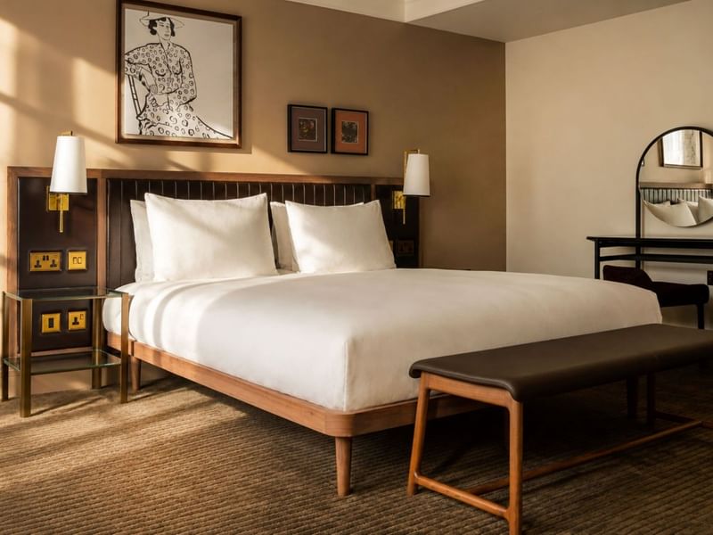 Collection Superior room with white bedding, wooden furniture, wall sconces, and framed artwork at The May Fair Hotel, London