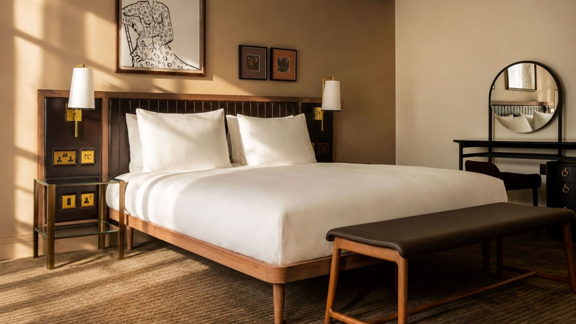 Ottoman and dressing table by the cozy bed in the Collection Superior Room with carpeted floors at The May Fair Hotel