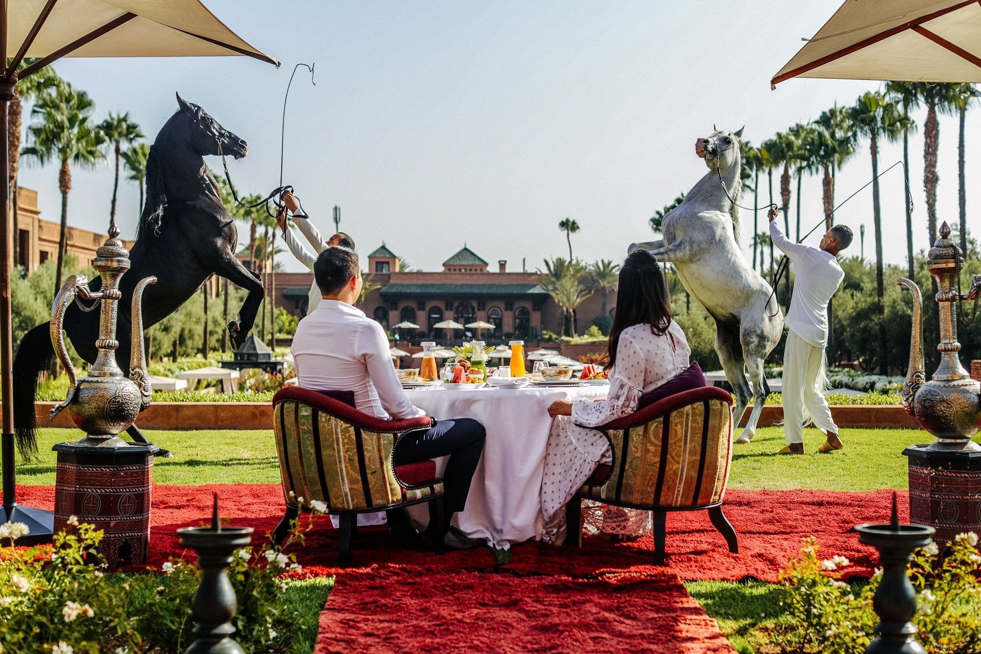 A couple enjoying outdoor lunch while watching horses at Selman Marrakech