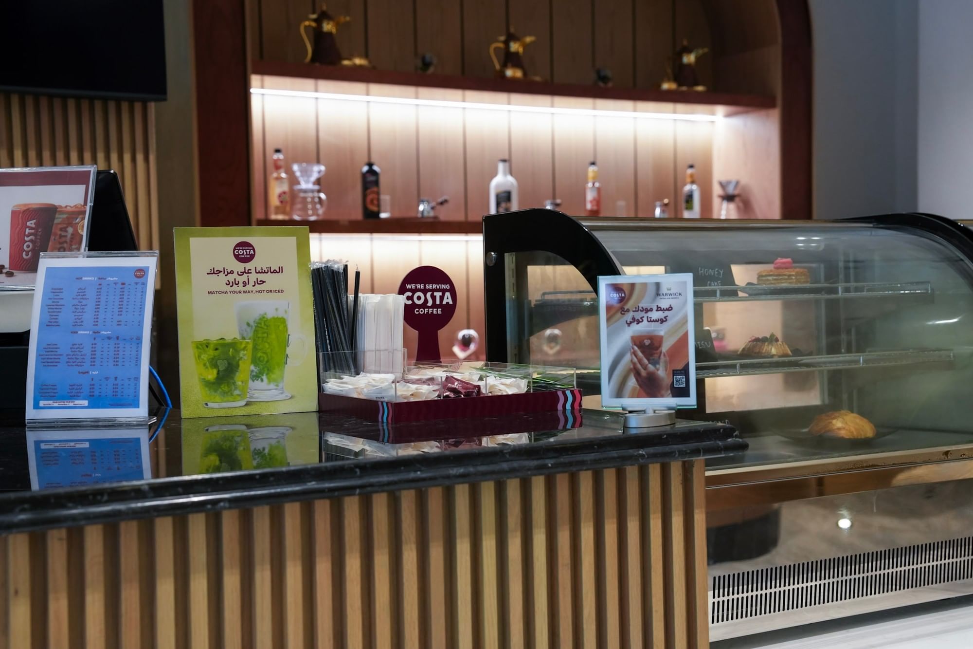 Coffee shop counter with pastries and drinks menu at Warwick Hotel & Spa - Jeddah