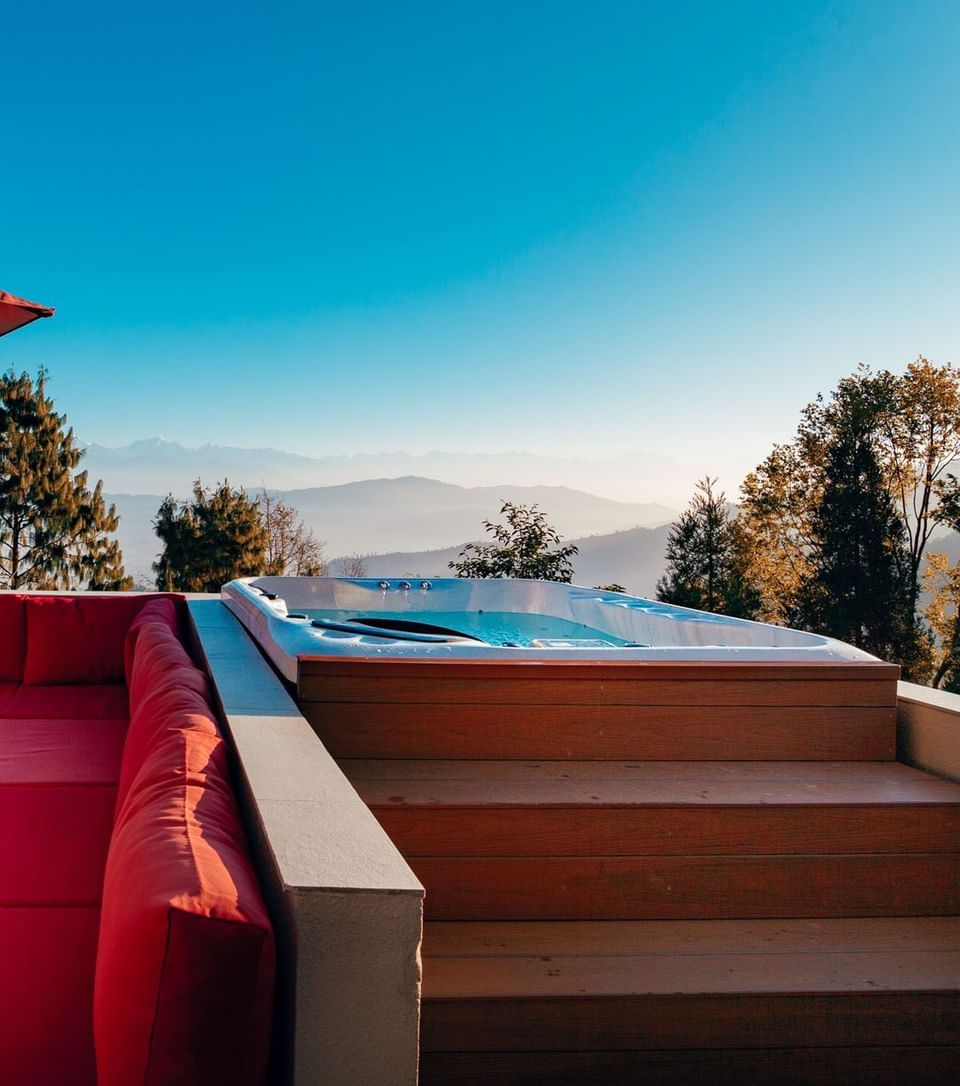 Terraces Presidential Suite Outdoor patio with a jacuzzi, cushions, and an umbrella at The Terraces Resort & Spa