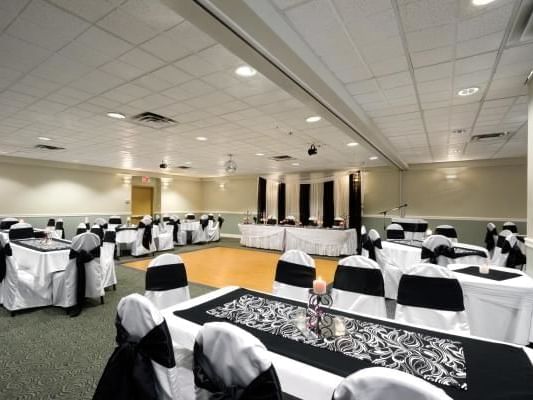 Interior & decor of a banquet room with dance floor and tables in Harrison Lake Hotel