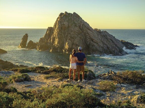 Couple posing on rocks at Pullman Bunker Bay Resort