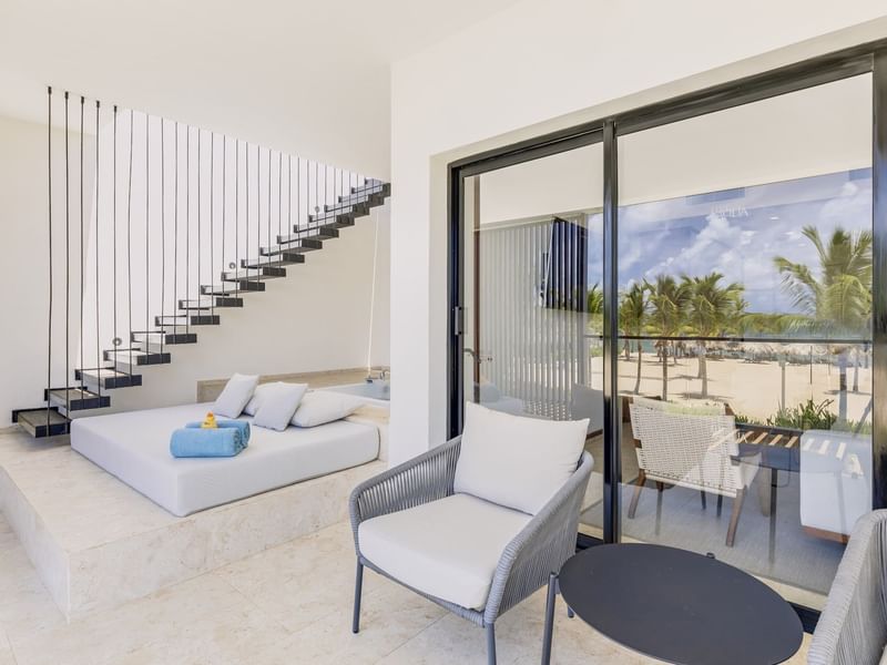 Living area with seating by the staircase in Viento Suite at Live Aqua Punta Cana