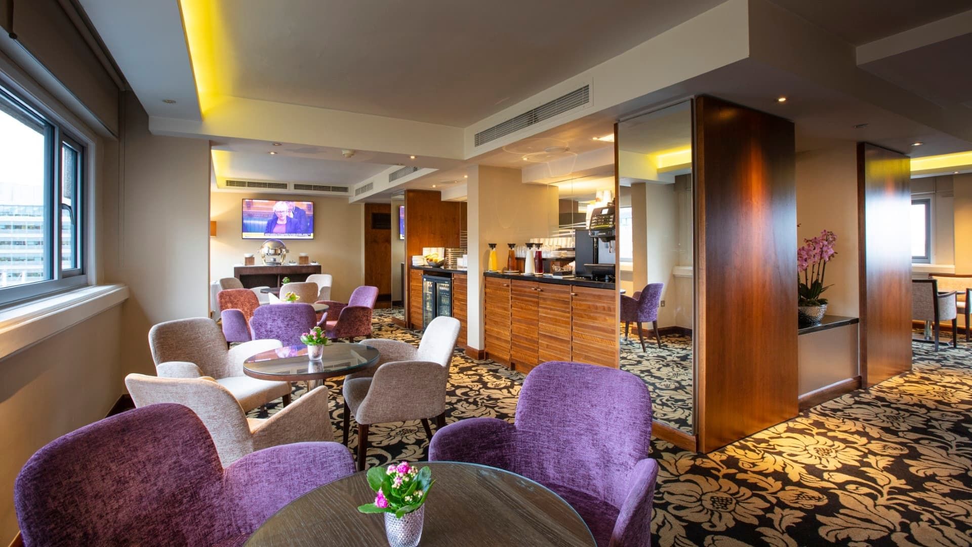 Interior of executive lounge area with wall TV at Guoman Hotels