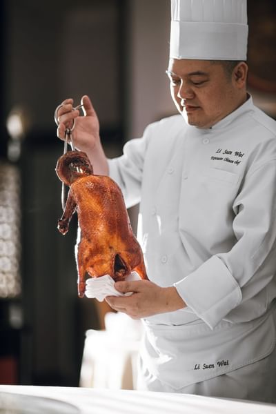 A chef presents roasted meat at Hanoi Daewoo Hotel