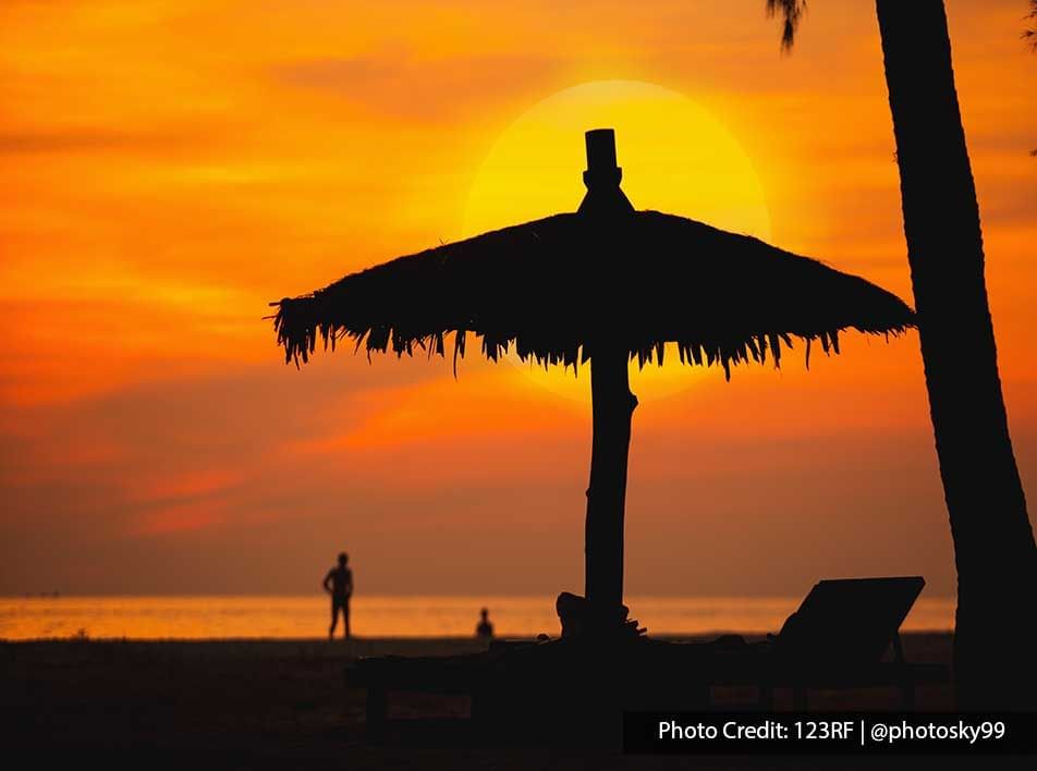 vibrant sunset behind beach umbrella - Grand Lexis PD