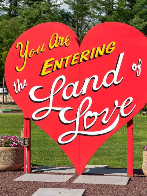 You Are Entering The Grand Land of Love sign in a park near Cove Pocono Resorts