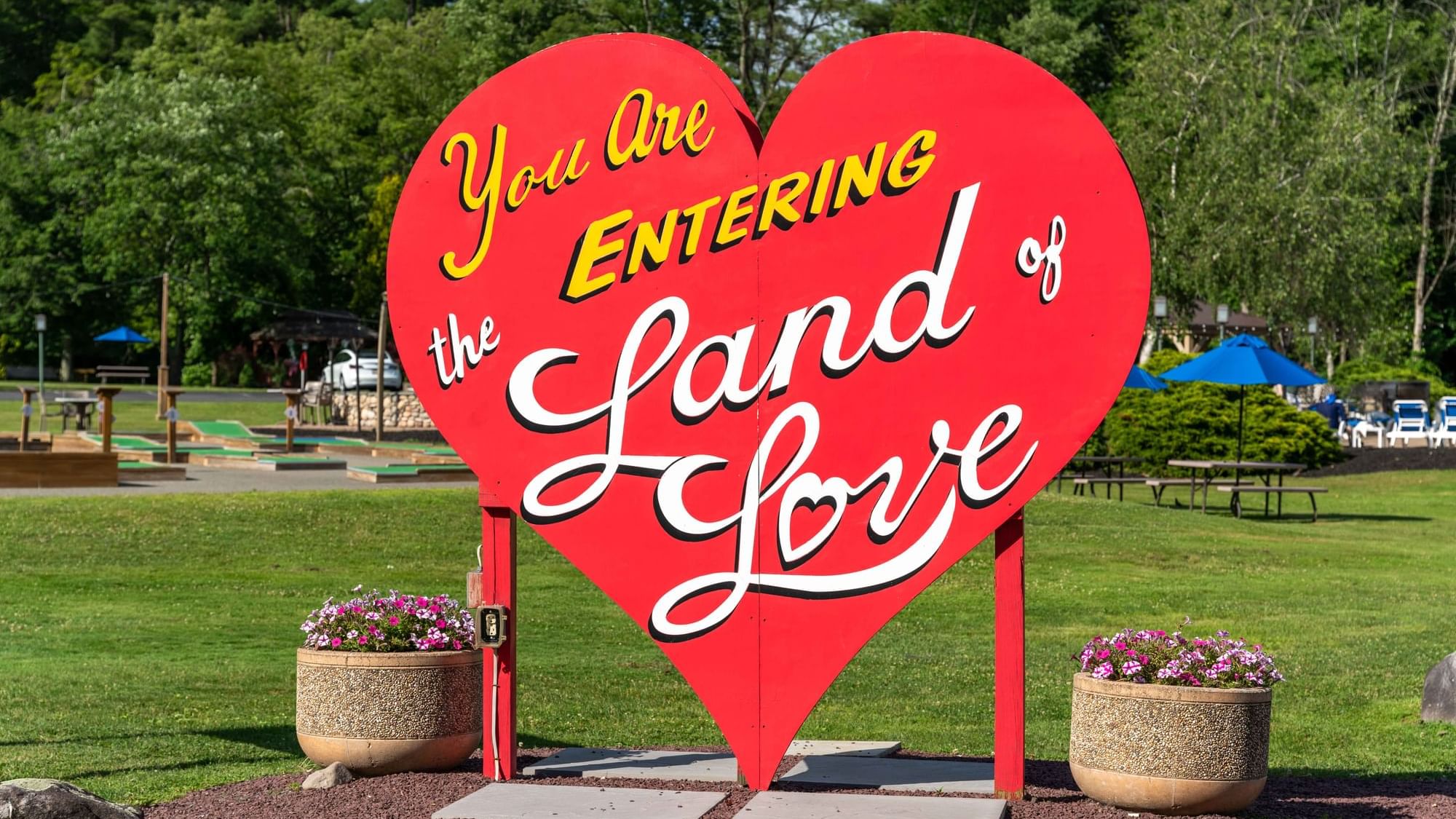 You Are Entering The Grand Land of Love sign in a park near Cove Pocono Resorts