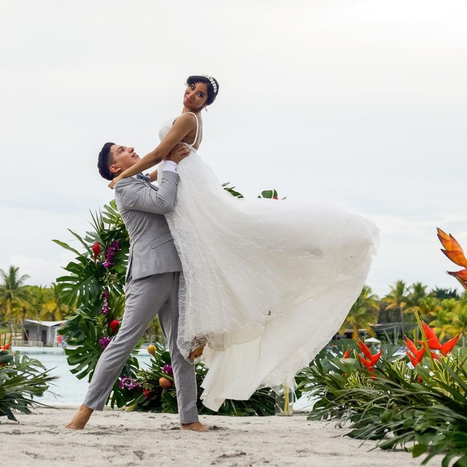 Newly wedded couple posing at Playa Blanca Beach Resort