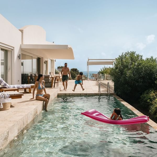 Family enjoying outdoor pool area at Falkensteiner Resort Capo Boi