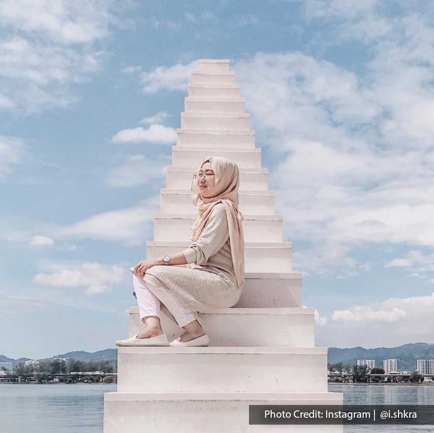 A woman was taking a picture with one of the famous landmarks in Pulau Jerejak called 'Stairway to Heaven' - Lexis Suites Penang