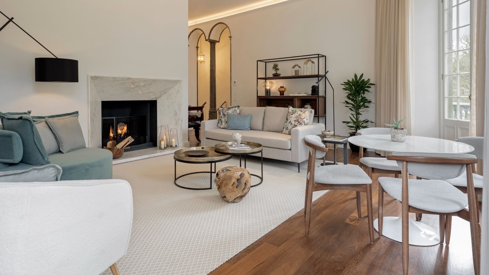 Luxury lounge area with a fireplace & wooden floors in a Villa at Bensaude Hotels Collection