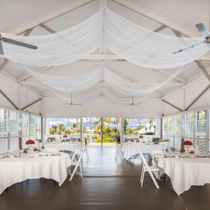Elegant dining setup in Plantation Deck windows showcasing tropical views at Mercure Hotel Townsville